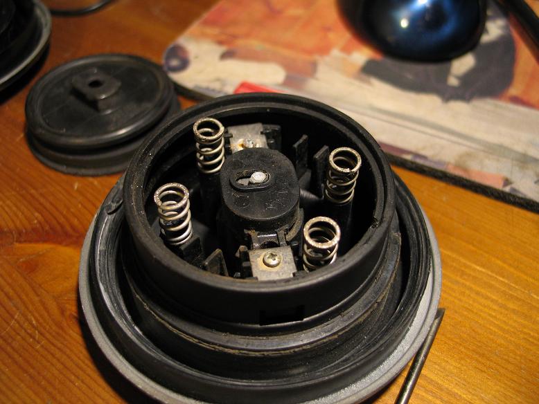 Springs also go flying, but not under big tension, cover with other hand if possible